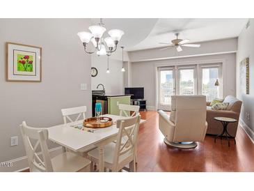 Bright dining area with hardwood floors and white table at 222 Glenwood # 602, Raleigh, NC 27603