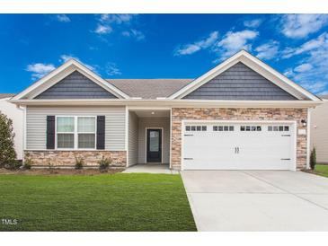 Ranch style home with stone and shingle accents, two-car garage, and landscaping at 108 Wilderness Ct, Mebane, NC 27302