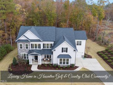 Luxury home in Hasentree Golf & Country Club community with a large front yard at 7100 Hasentree Club Dr, Wake Forest, NC 27587