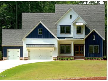 Two-story farmhouse with white siding and blue accents at 4332 Coldwater Springs Dr, Raleigh, NC 27616