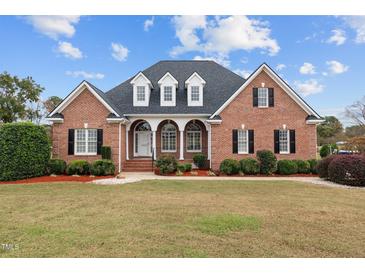 Brick house with a large front yard and landscaping at 7667 Briar Creek Rd, Rocky Mount, NC 27803