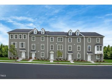 Three story townhomes with gray siding and white accents at 2213 Pitchfork Ln, Durham, NC 27713