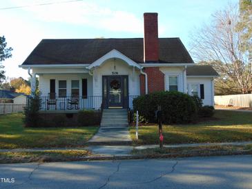 Charming one-story home with a brick chimney and front porch at 509 E Church St, Nashville, NC 27856