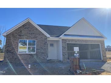 Brick front exterior of charming new construction home with a two-car garage at 55 Sawtooth Oak Ln, Youngsville, NC 27596