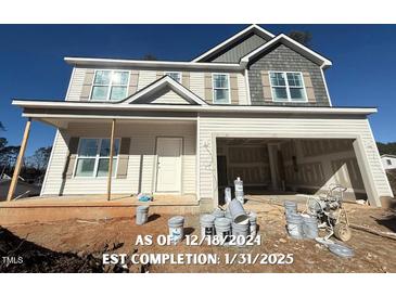 Two-story home with attached two-car garage, front yard, and large windows at 78 Bennett Rd, Coats, NC 27521