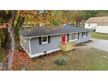 Newly renovated gray house with red door and landscaping at 509 Keith St, Knightdale, NC 27545