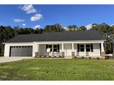 New construction home with a grey roof and a stone accent at 131 Tulipfield Way, Benson, NC 27504