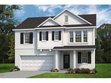 Two-story home with white siding, black windows, and a two-car garage at 8749 Maxine St # 11 Holly, Willow Springs, NC 27592
