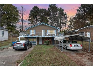 Brick house with carport and balcony, offering curb appeal at 511 Elmira Ave, Durham, NC 27707