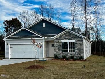 Two-story house with gray siding, stone accents, and a two-car garage at 7586 Michelle Rd, Rocky Mount, NC 27803