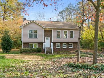 Two-story house with brick and siding, steps leading to the entrance, and a yard at 108 N Woodshed Ct, Cary, NC 27513