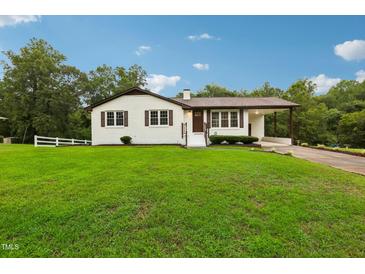 Charming ranch home with a spacious lawn and driveway at 2112 Eastwood Dr, Durham, NC 27703