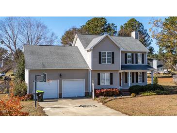 Two-story house with attached two-car garage and landscaped yard at 360 Sandy Ridge Rd, Dunn, NC 28334