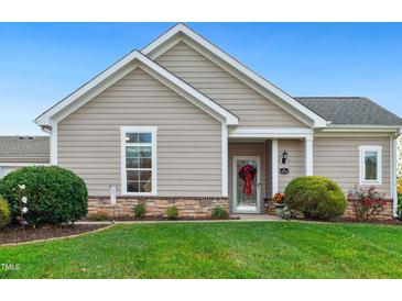 Exterior view of charming ranch home with landscaped lawn at 414 Faith Dr, Gibsonville, NC 27249