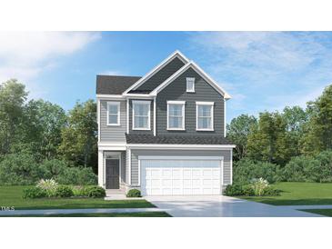 Two-story home with gray siding, white garage door, and landscaping at 1117 Atterlee Ln # 93, Graham, NC 27253