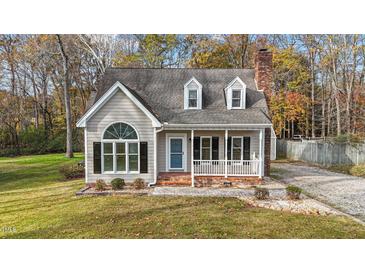 Beige house with gray roof, white trim, and a porch at 1208 Turnstone Dr, Rocky Mount, NC 27803