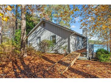 Lakefront home with wooded lot and steps leading to the water at 148 Silver Lake Pt Pt, Sanford, NC 27332