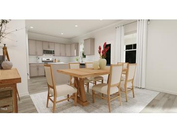 Bright dining room with wood table and chairs, adjacent to kitchen at 214 St Andrews Dr, Zebulon, NC 27597