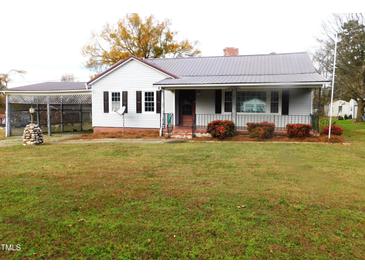 Charming ranch home with a metal roof and spacious yard at 477 Providence Rd, Roxboro, NC 27574