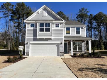 Two-story house with gray siding, white garage door, and landscaping at 244 Combine Trl # Dm 108, Benson, NC 27504