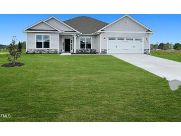 Two-story house with gray siding, white trim, and a three-car garage at 120 Lemon Drop Ln, Franklinton, NC 27525