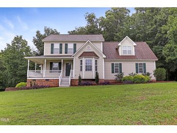 Two-story house with a large front porch and well-manicured lawn at 430 Carrington Dr, Garner, NC 27529