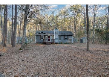 Gray house with red door, wooden deck, and wooded backyard at 9100 Greenbriar Sta, Chapel Hill, NC 27516