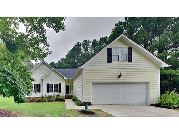 Suburban home with attached garage and manicured lawn at 1112 Minnie Dr, Raleigh, NC 27603