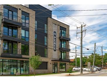 Modern apartment building exterior with large windows and brick facade at 615 W Peace St # 302, Raleigh, NC 27605