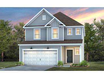 Two-story home with gray siding, white garage door, and landscaping at 2782 Farmhouse Dr, Apex, NC 27502