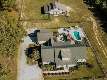 Aerial view of a house, pool, barn, and expansive grounds at 297 Denvale Dr, Selma, NC 27576