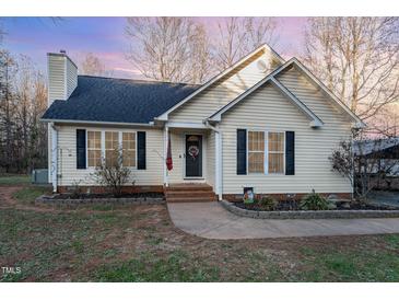 Charming one-story home with a landscaped yard and walkway at 4433 Spoon Loop Loop, Liberty, NC 27298