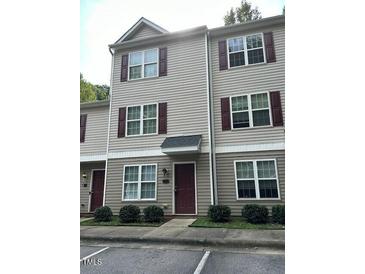 Two-story townhome with neutral siding and burgundy accents at 67 Red Ln, Raleigh, NC 27606