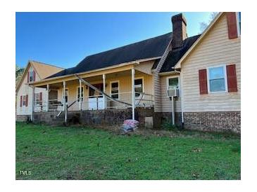 Ranch-style home with covered porch and large yard at 340 Cedar Grove Dr, Henderson, NC 27537