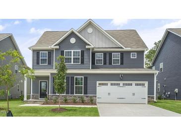 Two-story home with gray siding, white trim, and a two-car garage at 516 Lemon Daisy Ln, Knightdale, NC 27545