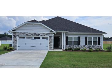 Two-story house with stone accents and a two-car garage at 54 Northwood Dr, Fuquay Varina, NC 27526