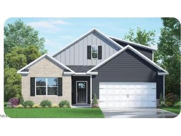 Two-story home with gray siding, brick accents, and a two-car garage at 7556 Percussion Dr, Apex, NC 27539