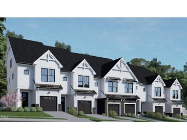 Modern three-story townhouses with attached garages and landscaped yards at 4041 Elk Creek Ln # 16, Raleigh, NC 27612