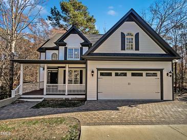Two-story house with white siding, black accents, and a paved driveway at 4700 Linaria Ln, Fuquay Varina, NC 27526