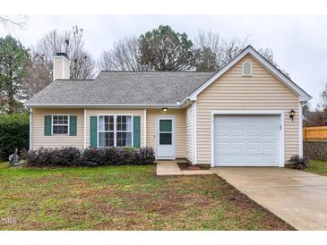 Cute ranch home with green shutters and a white garage door at 612 Kinship Ln, Apex, NC 27502