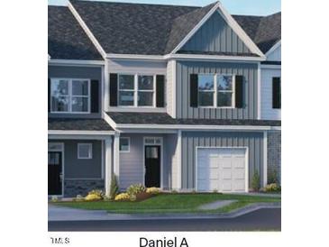 Two-story townhome with gray siding and white trim at 2203 Carcillar Dr, Apex, NC 27539