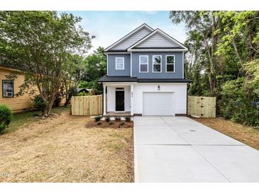 Charming two-story home with a fenced yard and driveway at 807 E Harnett St, Dunn, NC 28334