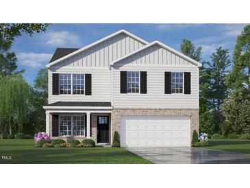 Two-story house with white siding, black shutters, and a two-car garage at 900 Canis Minor Rd, Wendell, NC 27591