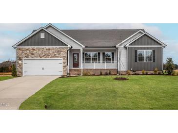 Newly constructed home with stone accents and a two-car garage at 11300 International Dr, Middlesex, NC 27557