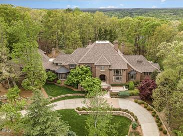 Luxury home nestled in wooded lot with circular driveway at 32520 Archdale Dr, Chapel Hill, NC 27517