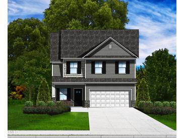 Two-story house with gray siding, white garage door, and landscaping at 262 Grand Griffon Way, Lillington, NC 27546