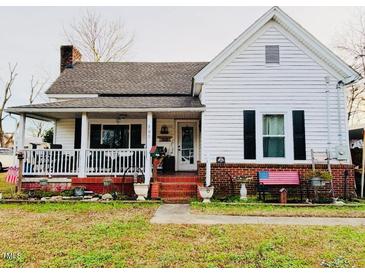 Charming white house with a front porch and landscaped yard at 305 W K St, Erwin, NC 28339