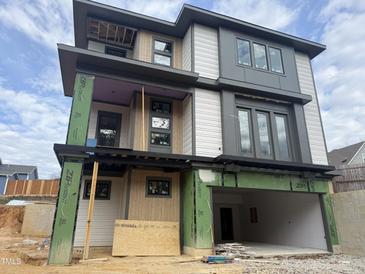 Modern three-story home with a two-car garage and a covered balcony at 409 Waldo St, Cary, NC 27511