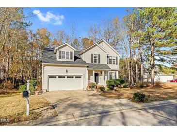 Two-story home with a two-car garage and landscaping at 900 Creek Haven Dr, Holly Springs, NC 27540