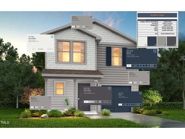 Two-story home with white and navy siding, a covered entryway, and landscaping at 228 Maggie Ln, Roxboro, NC 27573